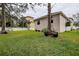 Landscaped backyard with lush lawn and privacy fence at 720 Sunset Dr, Tarpon Springs, FL 34689
