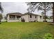 Spacious backyard with grassy lawn and partially covered patio at 720 Sunset Dr, Tarpon Springs, FL 34689