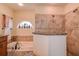 Bathroom with soaking tub, walk-in shower, and granite accents at 720 Sunset Dr, Tarpon Springs, FL 34689