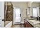 Bathroom features granite vanity, tiled shower and tub, and exterior access at 720 Sunset Dr, Tarpon Springs, FL 34689