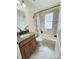 Clean bathroom with shower/tub combo, granite vanity, and updated fixtures at 720 Sunset Dr, Tarpon Springs, FL 34689