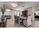 Bright dining room with a wood table and access to the kitchen and living room at 720 Sunset Dr, Tarpon Springs, FL 34689