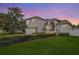 Two-story house with stone accents, landscaped lawn, and a two-car garage at 720 Sunset Dr, Tarpon Springs, FL 34689