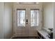Double front doors with beveled glass and a small bench at 720 Sunset Dr, Tarpon Springs, FL 34689