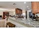 Open kitchen with granite counters and breakfast bar at 720 Sunset Dr, Tarpon Springs, FL 34689