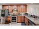 Modern kitchen with granite countertops and stainless steel appliances at 720 Sunset Dr, Tarpon Springs, FL 34689
