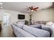 Bright living room featuring a sectional sofa and ceiling fan at 720 Sunset Dr, Tarpon Springs, FL 34689