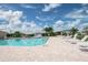 Sparkling community pool with lounge chairs at 7800 Kay Marie Ave, Zephyrhills, FL 33541