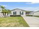 Single-story home with landscaped lawn at 7800 Kay Marie Ave, Zephyrhills, FL 33541