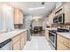 Galley kitchen with stainless steel appliances at 7800 Kay Marie Ave, Zephyrhills, FL 33541
