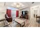 Living room with fireplace and large TV at 7800 Kay Marie Ave, Zephyrhills, FL 33541