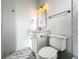 Bathroom featuring a white vanity, toilet, and patterned tile floor at 9050 San Martin Ne Blvd, St Petersburg, FL 33702