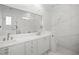 Elegant bathroom with marble walls, double vanity and a tub at 9050 San Martin Ne Blvd, St Petersburg, FL 33702