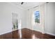Bedroom with hardwood floors, en-suite bathroom, and large window at 9050 San Martin Ne Blvd, St Petersburg, FL 33702