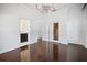 Spacious bedroom with hardwood floors, chandelier, and en-suite bathroom at 9050 San Martin Ne Blvd, St Petersburg, FL 33702