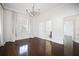 Bedroom with hardwood floors, chandelier, and access to a bathroom at 9050 San Martin Ne Blvd, St Petersburg, FL 33702