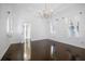 Elegant bedroom with hardwood floors, chandelier and white walls at 9050 San Martin Ne Blvd, St Petersburg, FL 33702