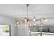 Elegant chandelier with crystal accents, perfect for a dining room or living area at 9050 San Martin Ne Blvd, St Petersburg, FL 33702