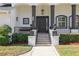 Elegant entryway with a dark wood door and decorative planters at 9050 San Martin Ne Blvd, St Petersburg, FL 33702