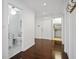 Bright hallway with hardwood floors, leading to bathroom and laundry room at 9050 San Martin Ne Blvd, St Petersburg, FL 33702