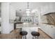 Spacious kitchen with white cabinets, marble countertops and island, stainless steel appliances at 9050 San Martin Ne Blvd, St Petersburg, FL 33702