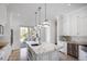 Bright kitchen features marble island, stainless steel appliances, and French doors to patio at 9050 San Martin Ne Blvd, St Petersburg, FL 33702