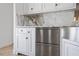 Modern kitchen features white cabinetry, marble countertops, and stainless steel appliances at 9050 San Martin Ne Blvd, St Petersburg, FL 33702