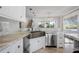 Modern kitchen with stainless steel appliances and a farmhouse sink at 9050 San Martin Ne Blvd, St Petersburg, FL 33702