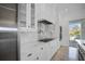 Bright kitchen boasts white cabinets, marble backsplash, and stainless steel appliances at 9050 San Martin Ne Blvd, St Petersburg, FL 33702