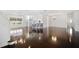 Open living space with hardwood floors, kitchen view, and staircase at 9050 San Martin Ne Blvd, St Petersburg, FL 33702