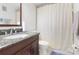 Bathroom with granite-topped vanity, shower/tub combo, and neutral decor at 1000 79Th N Ave # 102, St Petersburg, FL 33702