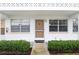 Front entrance of condo building, featuring landscaping and individual unit entrances at 1000 79Th N Ave # 102, St Petersburg, FL 33702