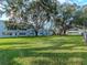 Expansive grassy area dotted with mature trees offers a tranquil setting for relaxation and outdoor enjoyment at 1000 79Th N Ave # 102, St Petersburg, FL 33702