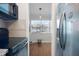 View from kitchen into dining area, showing kitchen appliances and flooring at 1000 79Th N Ave # 102, St Petersburg, FL 33702