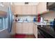 Galley kitchen with light wood cabinets, stainless steel appliances, and granite countertops at 1000 79Th N Ave # 102, St Petersburg, FL 33702