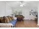 Living room with brown couch, ceiling fan, and wood-look flooring at 1000 79Th N Ave # 102, St Petersburg, FL 33702