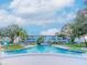 Inviting in-ground community pool surrounded by lush landscaping and a classic condominium building at 1000 79Th N Ave # 102, St Petersburg, FL 33702