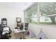 Sunroom with a workspace, comfortable seating, and large windows at 1000 79Th N Ave # 102, St Petersburg, FL 33702
