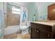 Bathroom with shower/tub combo and dark vanity at 10217 Bannister St, Spring Hill, FL 34608