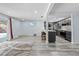 Modern kitchen with gray cabinets, stainless steel appliances, and breakfast bar at 10217 Bannister St, Spring Hill, FL 34608