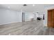 Open concept living area with grey vinyl flooring at 10217 Bannister St, Spring Hill, FL 34608