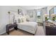Cozy bedroom with a queen bed, window seat, and modern wall sconces at 10266 Kalamazoo Pl, Parrish, FL 34219