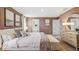 Main bedroom with a plush bed, large windows, and soothing color palette at 10266 Kalamazoo Pl, Parrish, FL 34219