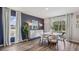 Modern dining room with round table, chairs, and hardwood floors at 10266 Kalamazoo Pl, Parrish, FL 34219