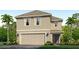 Two-story house with gray siding, two-car garage, and landscaping at 10266 Kalamazoo Pl, Parrish, FL 34219