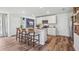 Modern kitchen with white cabinets, granite countertops, and island with seating at 10266 Kalamazoo Pl, Parrish, FL 34219