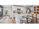 Open concept kitchen with white cabinets, granite island and stainless steel appliances at 10266 Kalamazoo Pl, Parrish, FL 34219