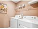 Convenient laundry room with washer, dryer, and overhead shelving at 10266 Kalamazoo Pl, Parrish, FL 34219