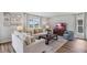 Spacious living room with hardwood floors, large windows, and neutral decor at 10266 Kalamazoo Pl, Parrish, FL 34219