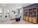 Spacious loft with blue accent wall, built in shelving and comfortable seating at 10266 Kalamazoo Pl, Parrish, FL 34219